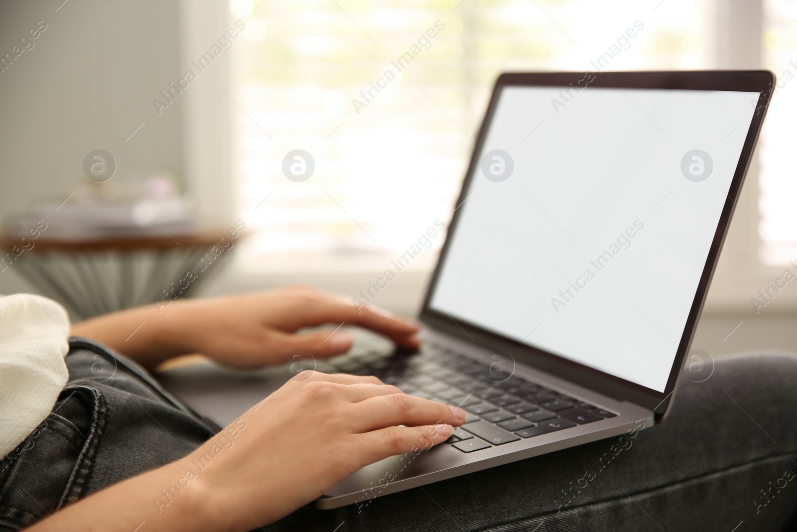 Photo of Woman working with modern laptop indoors, closeup