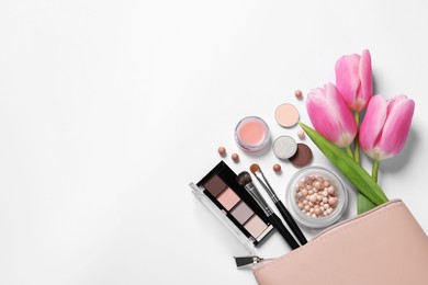 Flat lay composition with different makeup products and beautiful tulips on white background, space for text