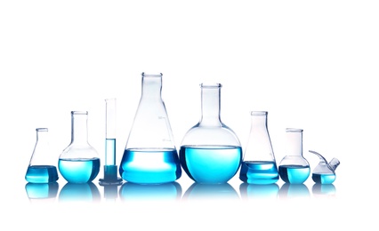 Photo of Laboratory glassware for chemical analysis with blue liquid on table against white background