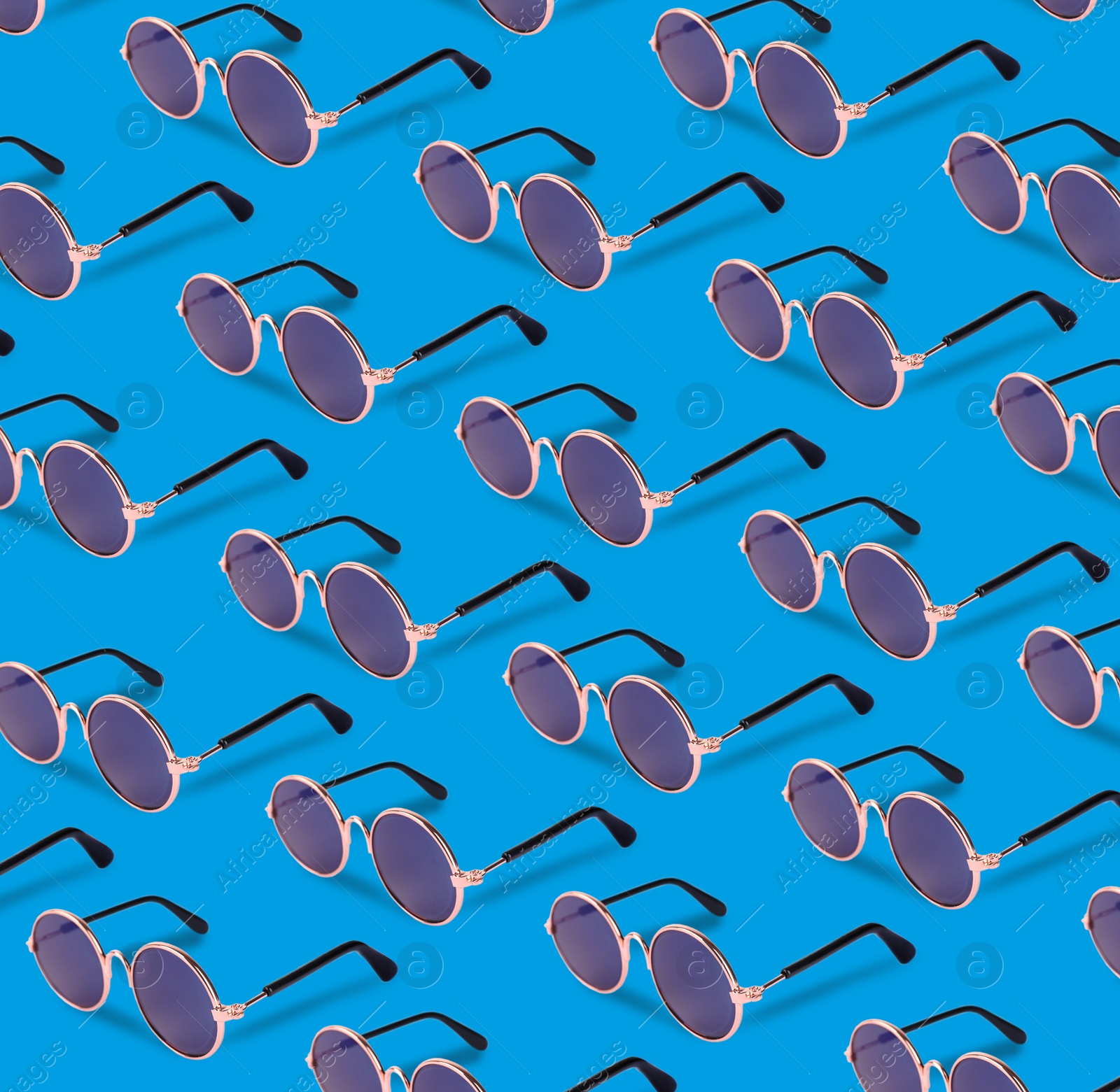 Image of Many stylish sunglasses on light blue background. Seamless pattern design