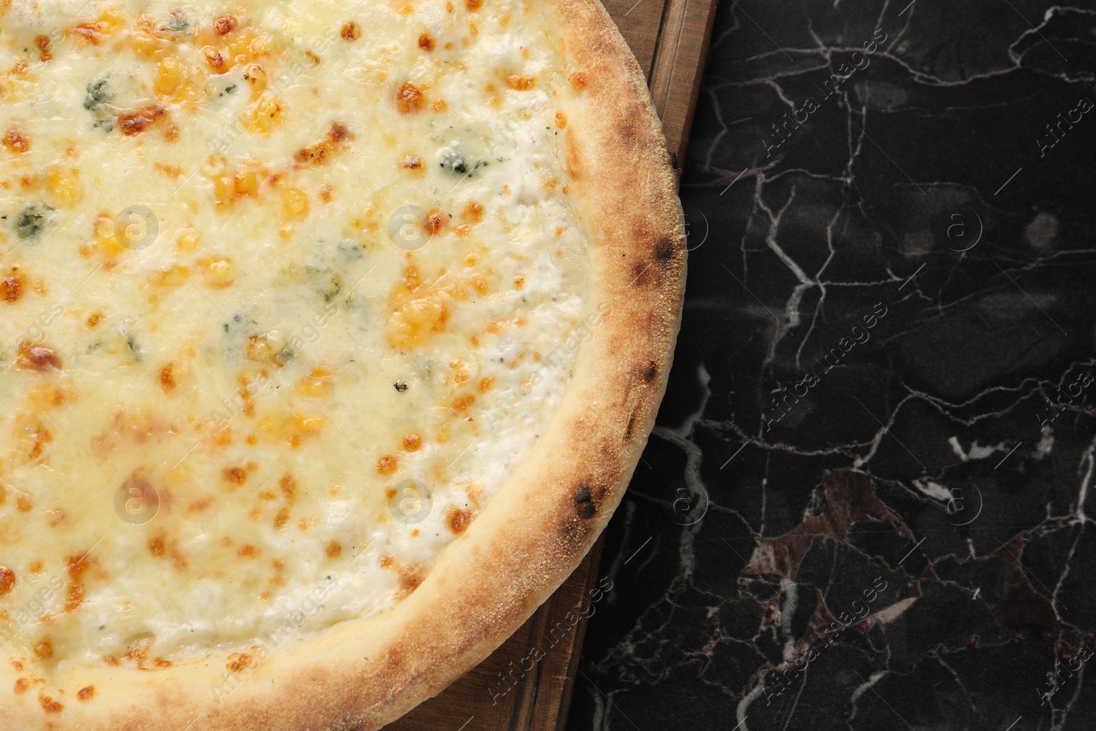 Photo of Delicious cheese pizza on black marble table, top view. Space for text