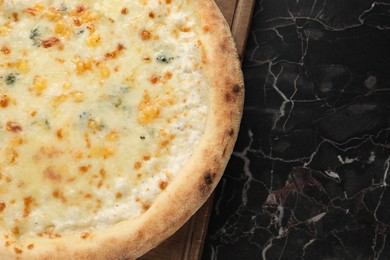 Delicious cheese pizza on black marble table, top view. Space for text