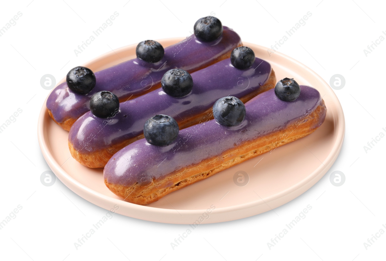 Photo of Delicious eclairs decorated with blueberries isolated on white