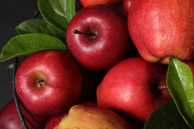 Photo of Fresh ripe red apples with water drops in metal bowl, closeup