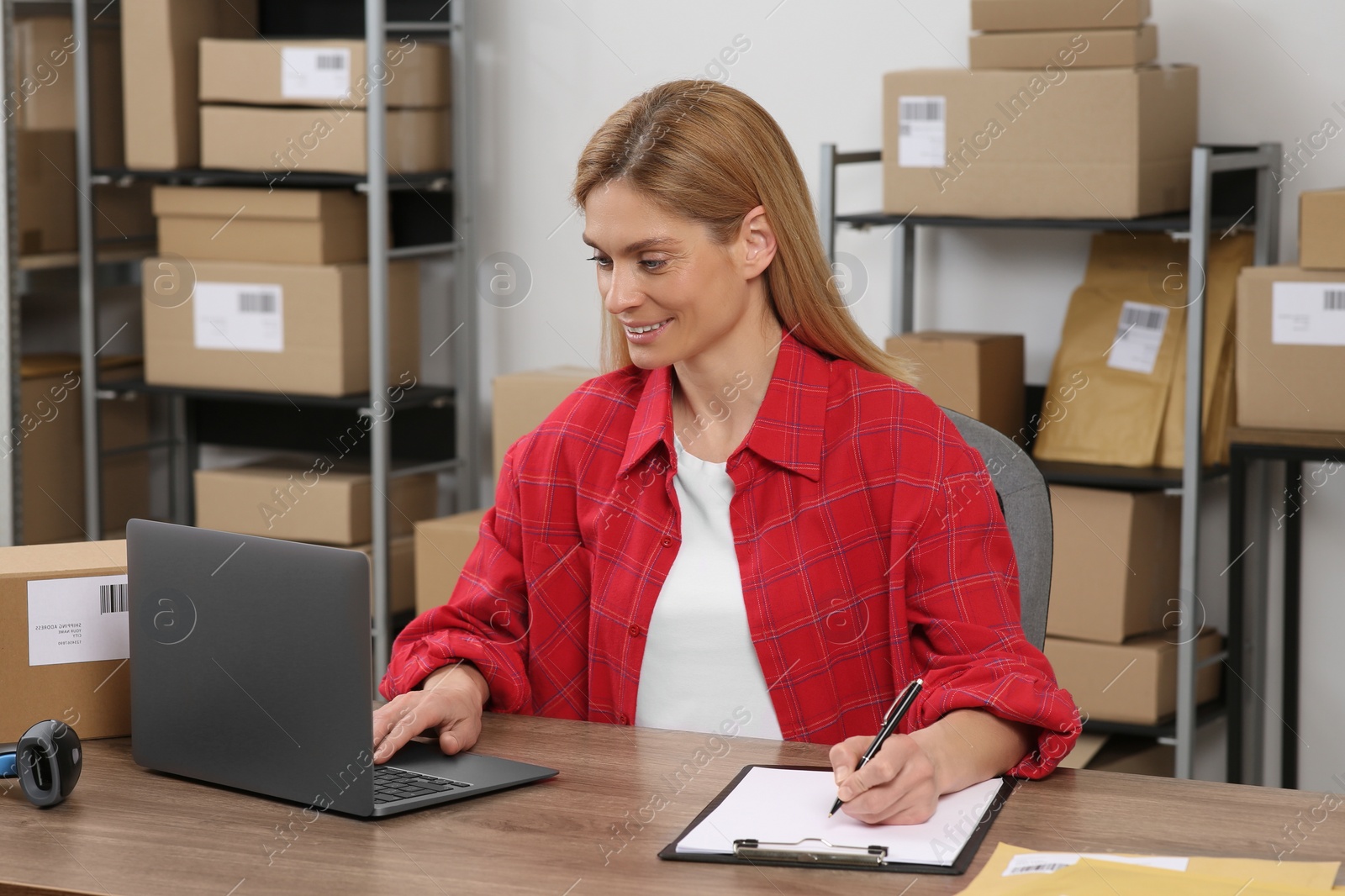 Photo of Seller with laptop working in office. Online store