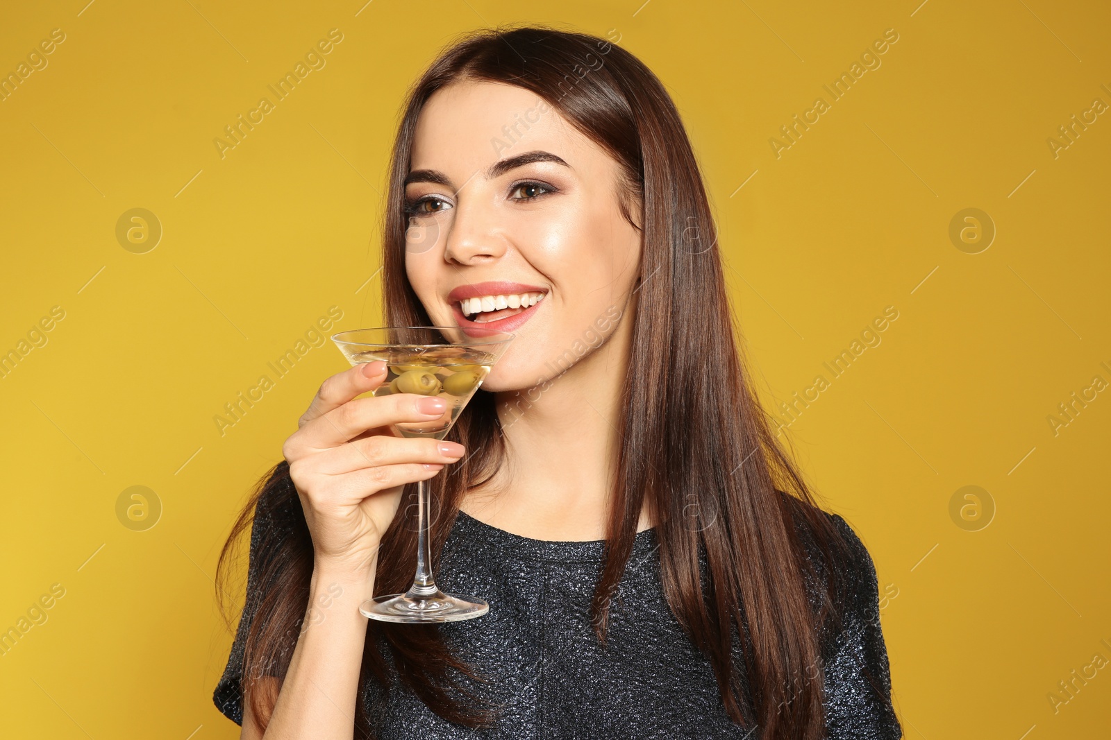 Photo of Beautiful young woman with glass of martini cocktail on color background