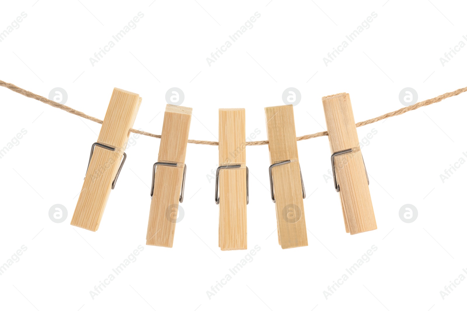 Photo of Many wooden clothespins on rope against white background