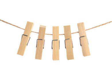 Many wooden clothespins on rope against white background