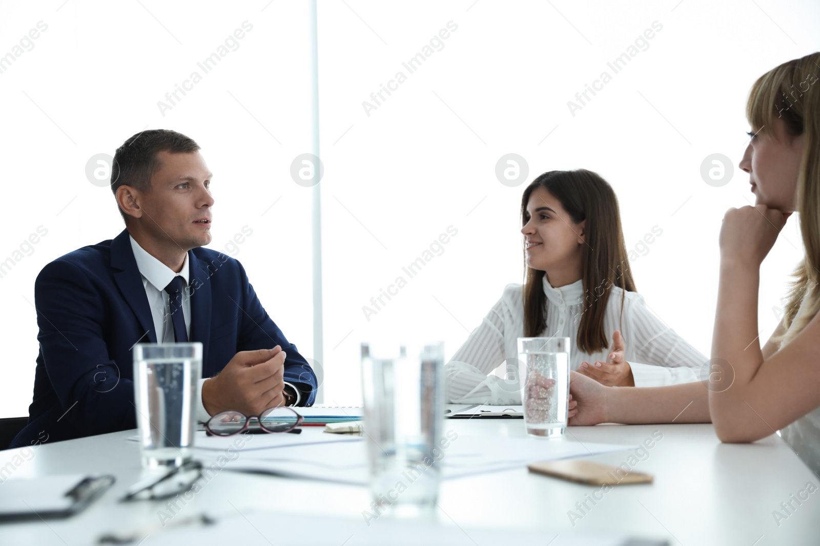 Photo of Office employees talking at table during meeting