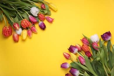 Photo of Beautiful colorful tulip flowers on yellow background, flat lay. Space for text