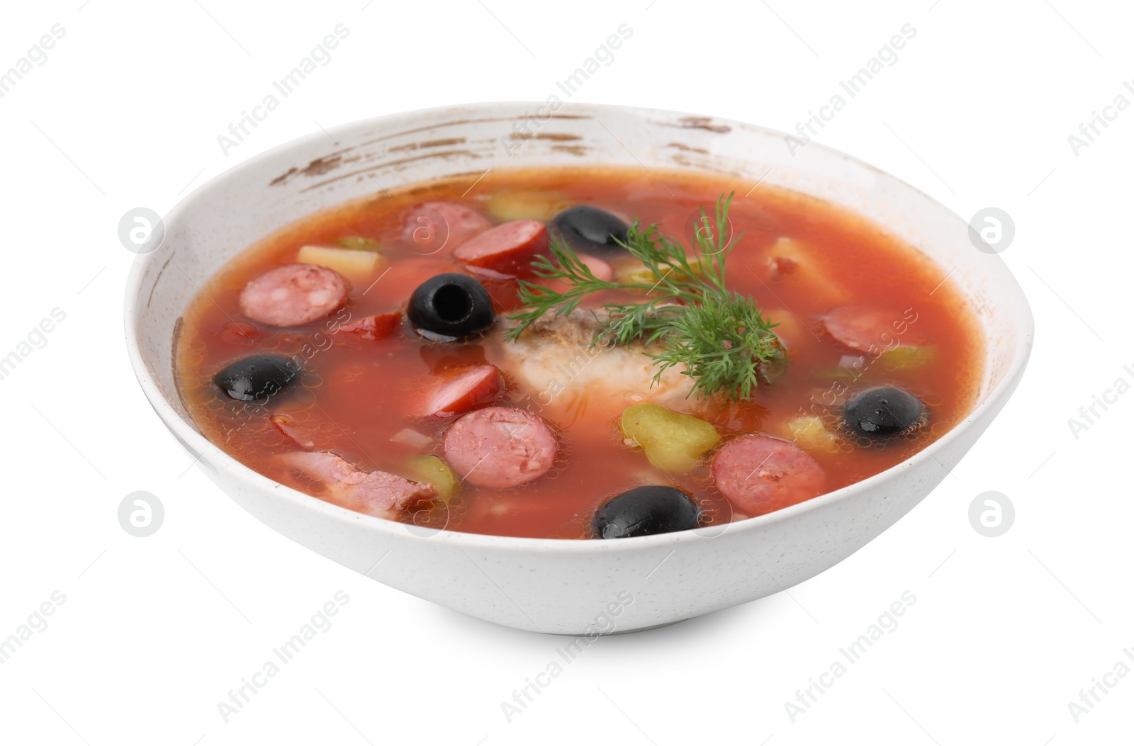 Photo of Meat solyanka soup with thin dry smoked sausages in bowl isolated on white