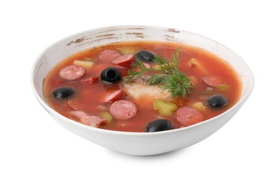 Photo of Meat solyanka soup with thin dry smoked sausages in bowl isolated on white