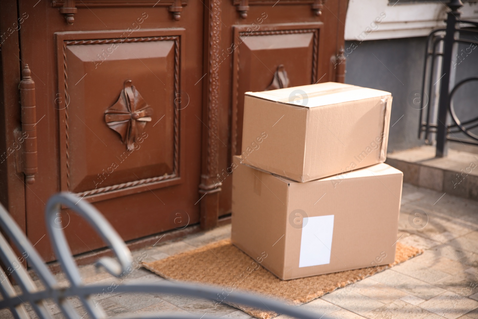 Photo of Delivered parcels on door mat near entrance