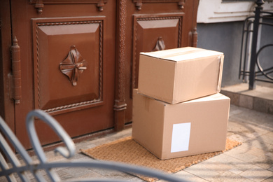 Photo of Delivered parcels on door mat near entrance