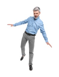 Photo of Mature businessman in stylish clothes posing on white background, low angle view