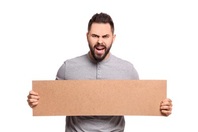 Angry young man holding blank cardboard banner on white background, space for text