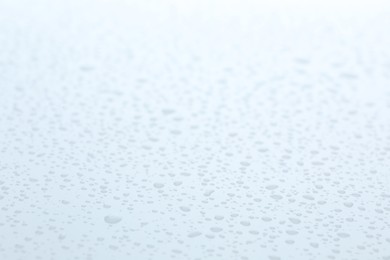 Photo of Water drops on white background, closeup view