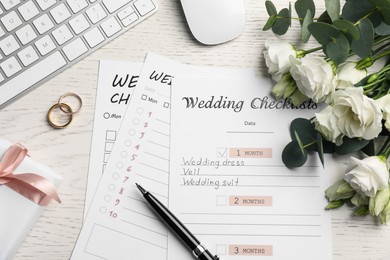 Flat lay composition with Wedding Checklists on white wooden table