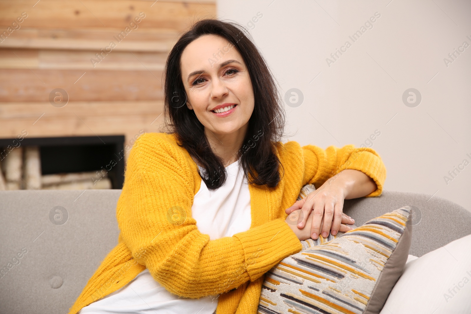 Photo of Beautiful mature woman on sofa at home