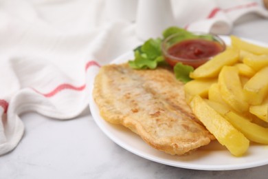 Delicious fish and chips with ketchup and lettuce on light table, closeup