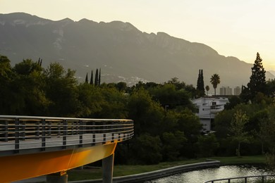 Bridge in park near mountains at sunset