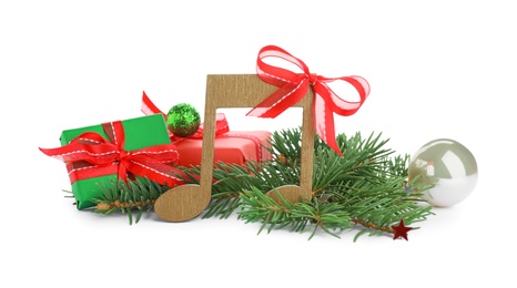 Photo of Wooden music note with fir tree branches and Christmas decor on white background