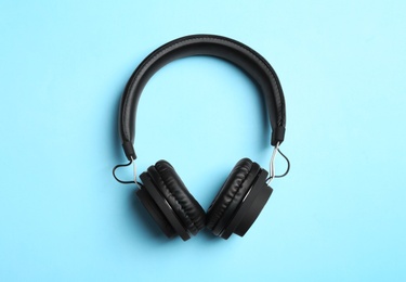 Photo of Stylish headphones on color background, top view