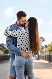 Photo of Young couple dancing outdoors on sunny day