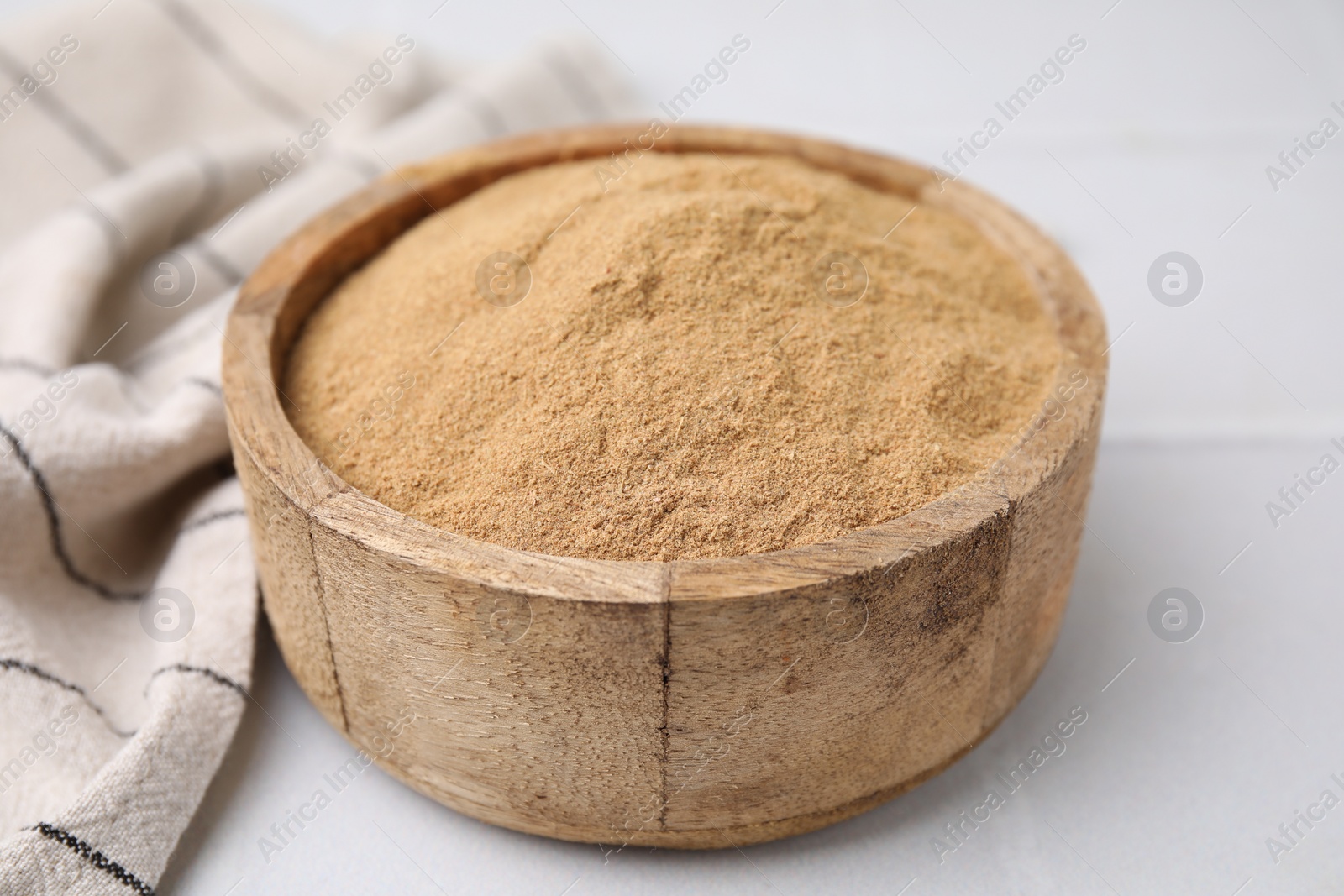 Photo of Dietary fiber. Psyllium husk powder in bowl on white table, closeup