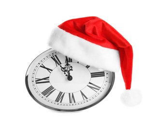 Photo of Clock with Santa hat showing five minutes until midnight on white background. New Year countdown
