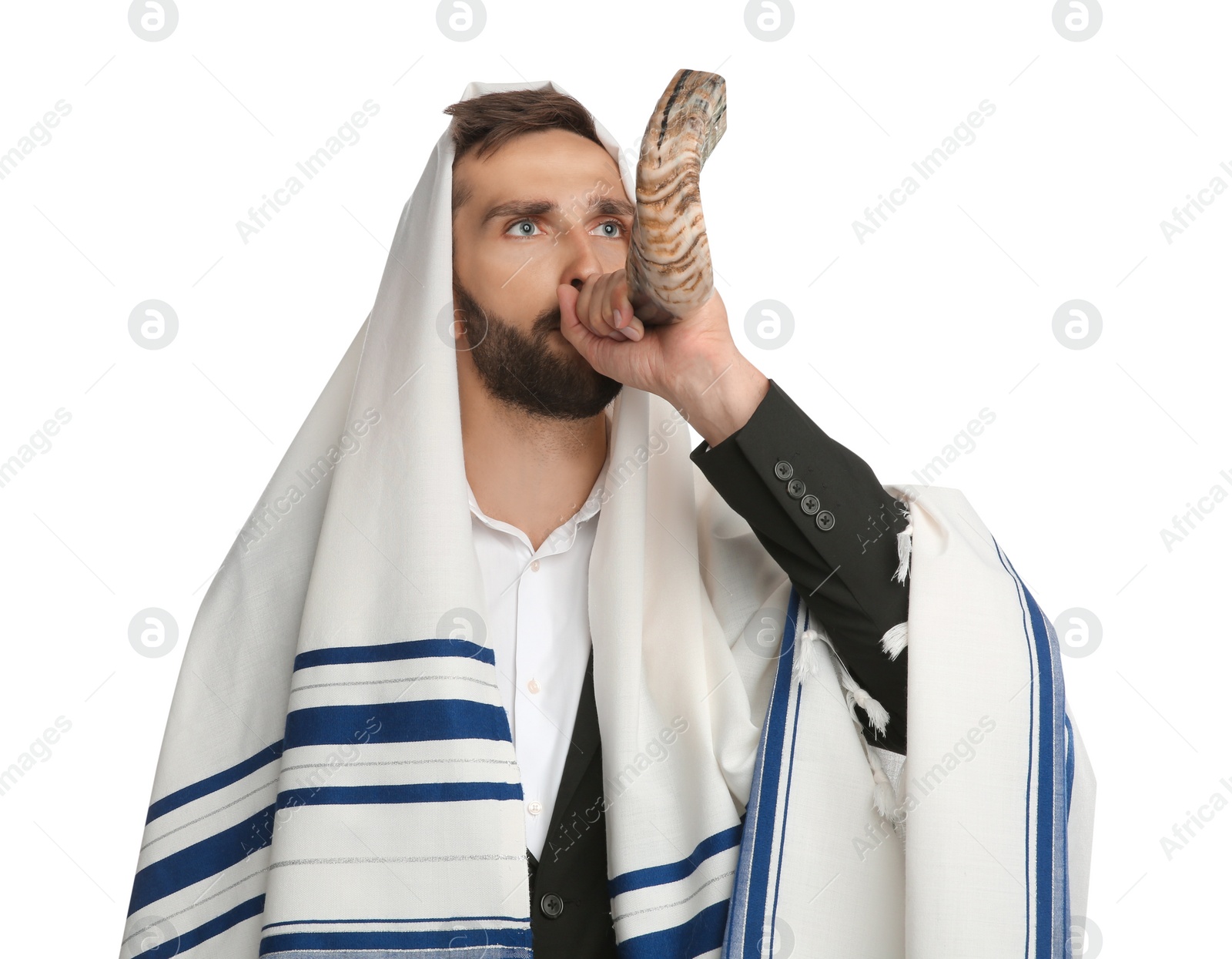 Photo of Jewish man in tallit blowing shofar on white background. Rosh Hashanah celebration