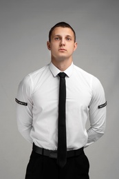 Photo of Male security guard in uniform on color background