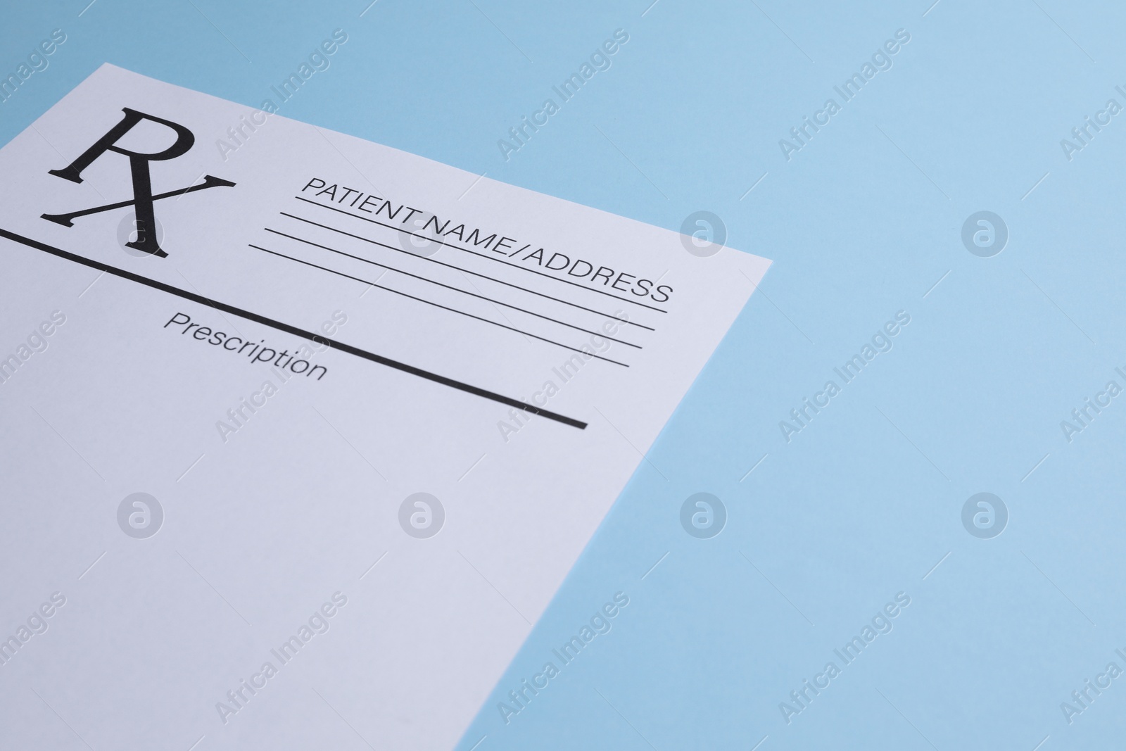 Photo of Medical prescription form on light blue background. Space for text