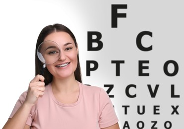 Vision test. Young woman with magnifying glass and eye chart on light background