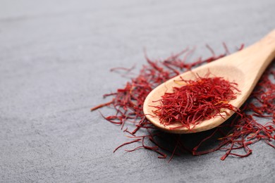 Photo of Dried saffron on grey table, closeup. Space for text