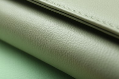 Photo of Green leather with seam on table, closeup