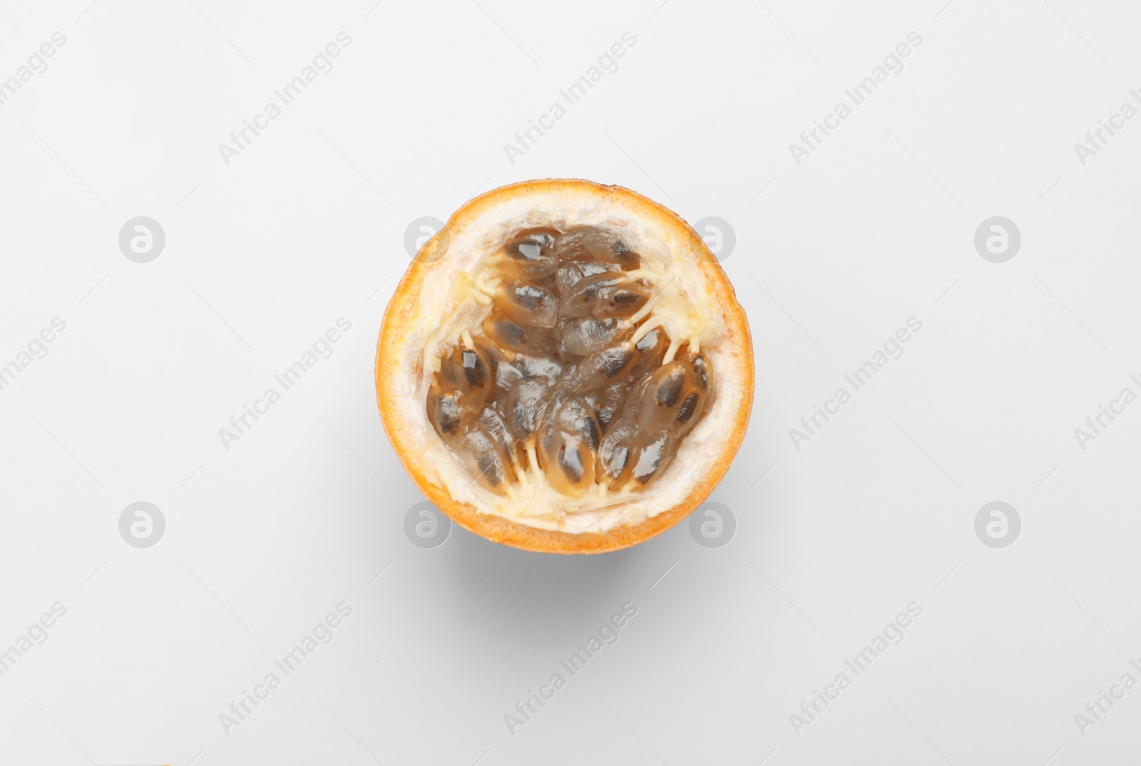 Photo of Half of granadilla on white background, top view