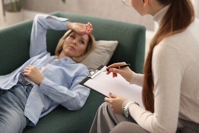 Photo of Professional psychotherapist working with patient in office