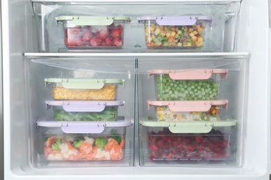 Boxes with different products inside of refrigerator