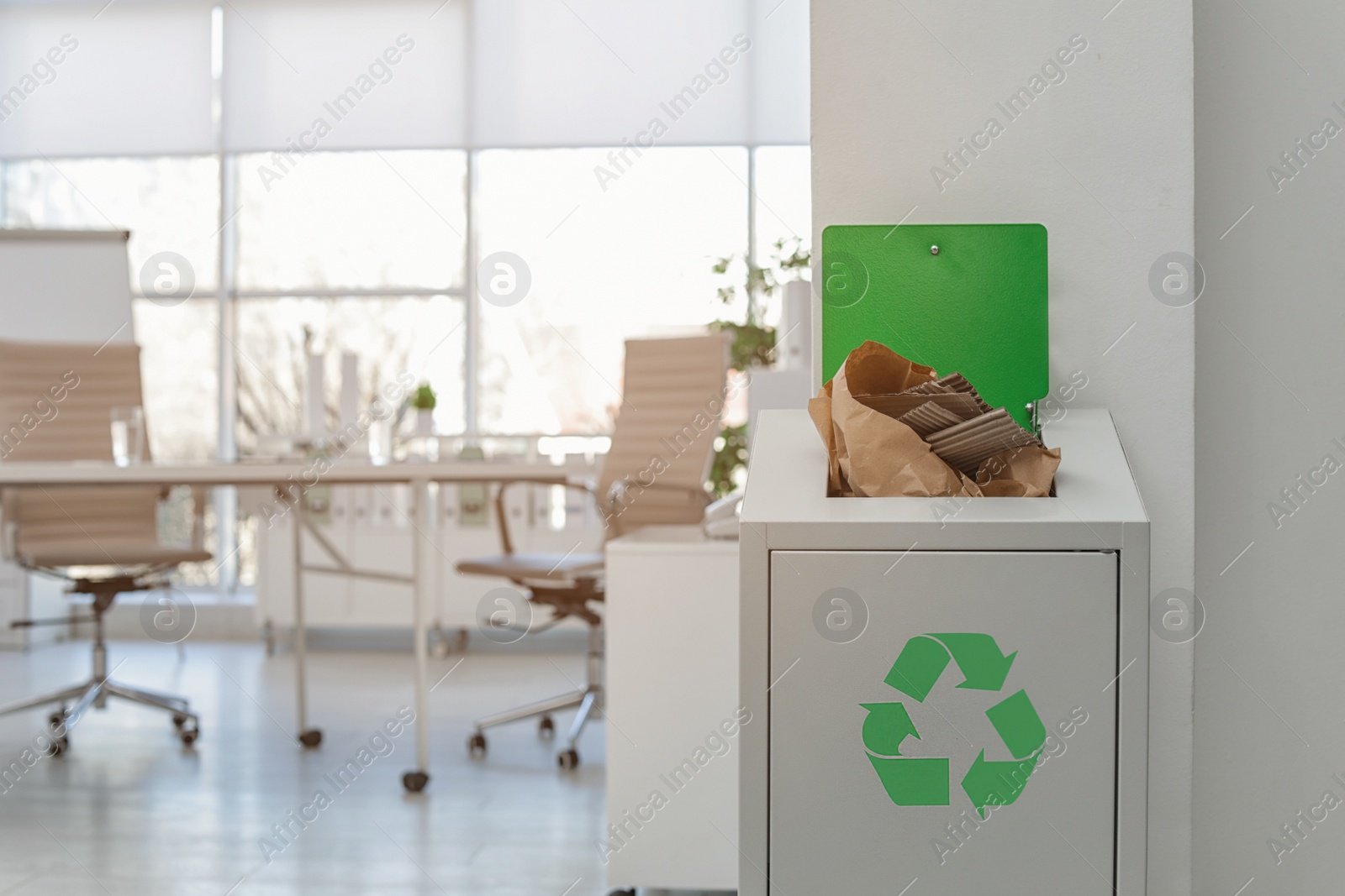 Photo of Open full trash bin in modern office, space for text. Waste recycling