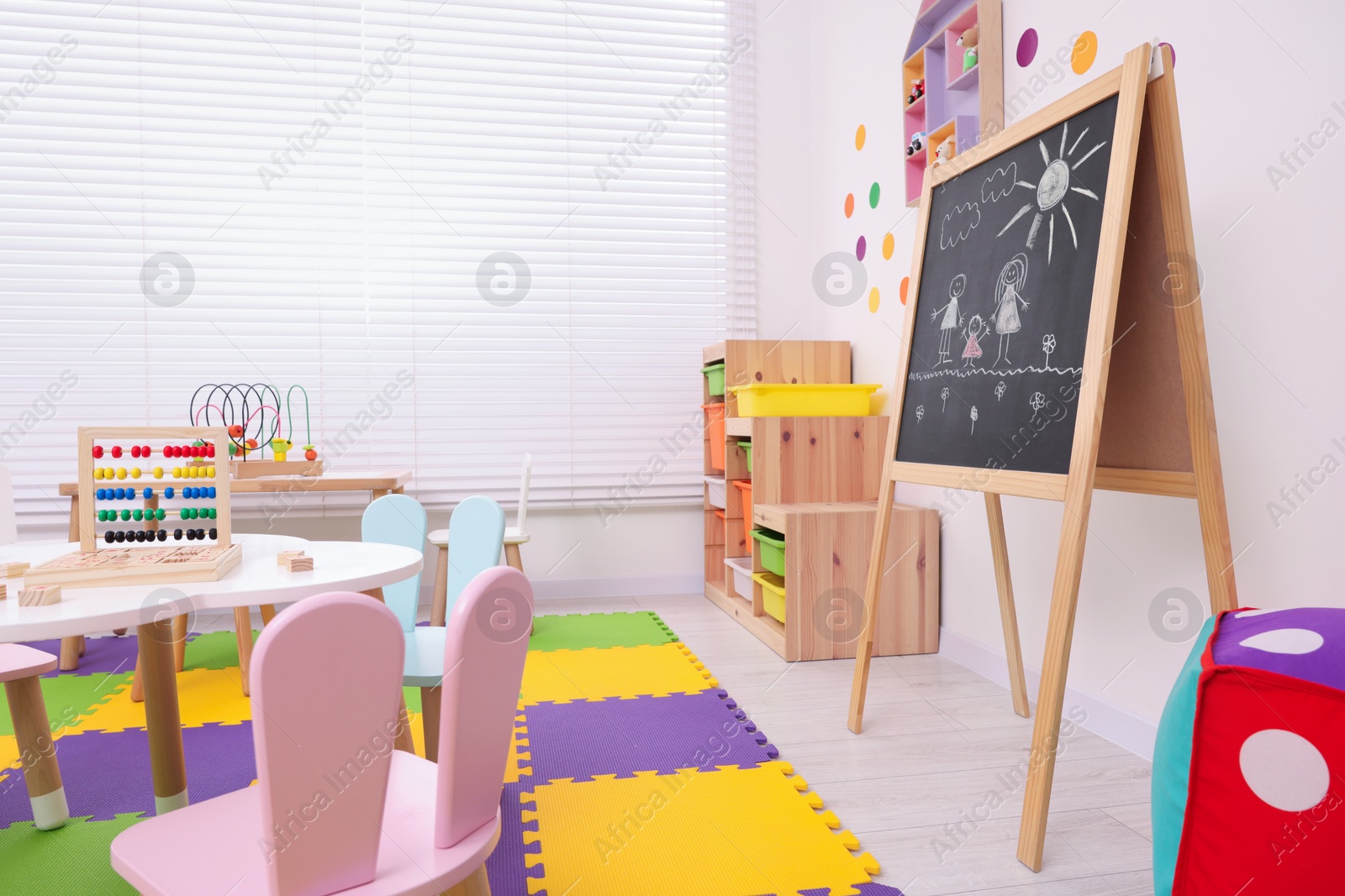 Photo of Stylish kindergarten interior with toys and modern furniture