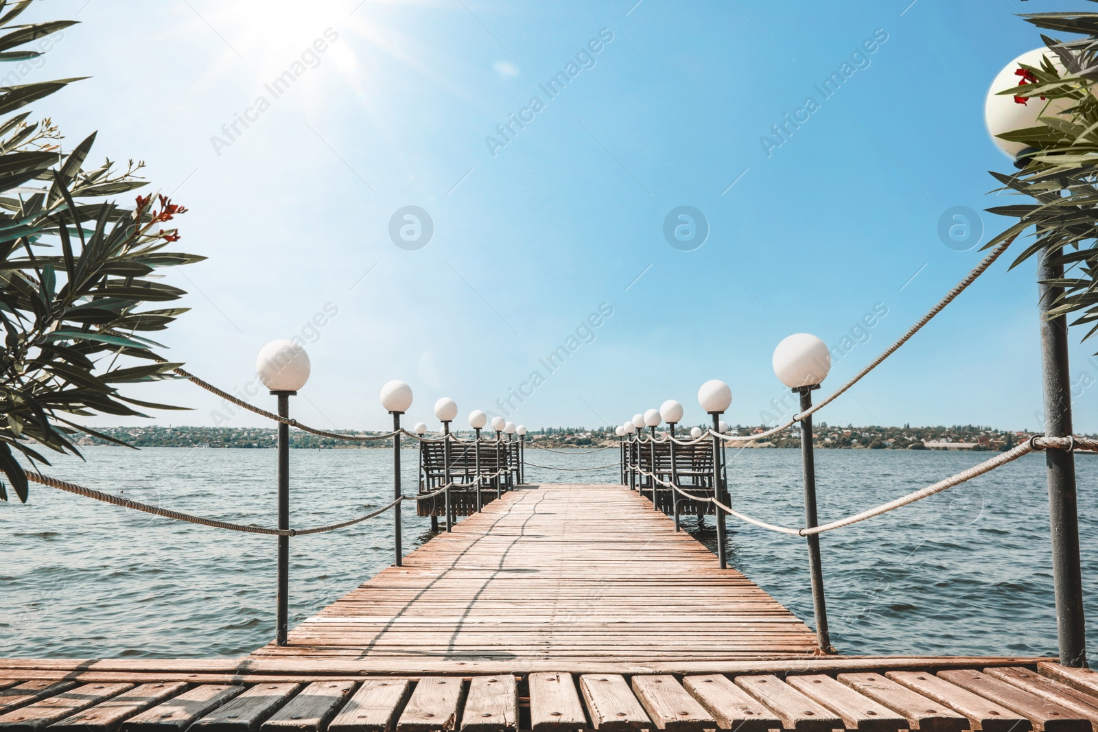 Photo of Beautiful river scene with wooden pier on sunny day