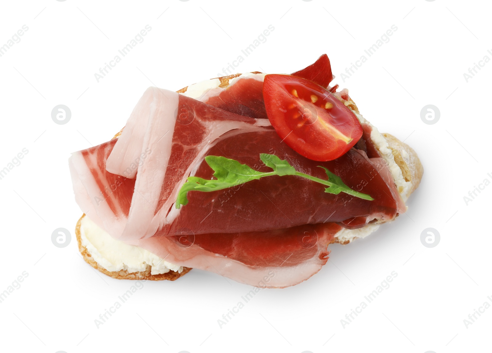 Photo of Tasty sandwich with cured ham, arugula and tomato isolated on white, top view