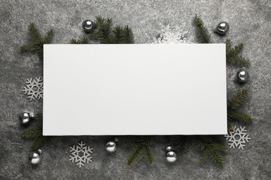Photo of Flat lay composition with blank canvas and Christmas decor on grey background. Mockup for design
