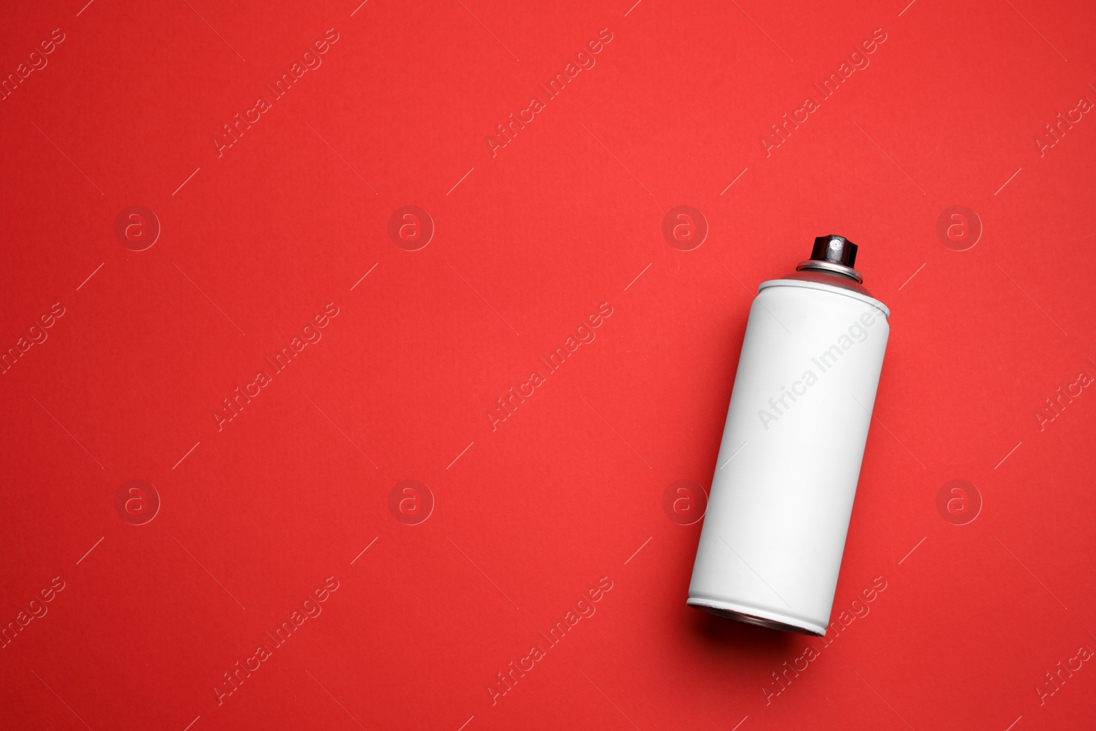 Photo of Can of spray paint on red background, top view with space for text. Graffiti supply