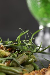 Delicious tarragon and baked vegetables on table, closeup. Space for text