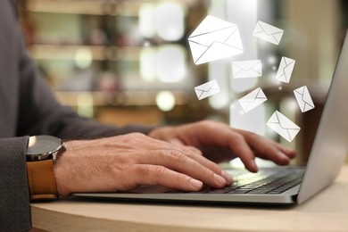 Image of Email. Man using laptop at table, closeup. Letter illustrations over device