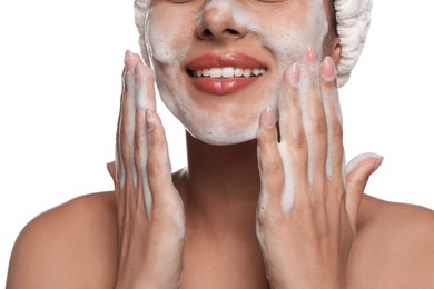 Beautiful woman applying facial cleansing foam on white background, closeup