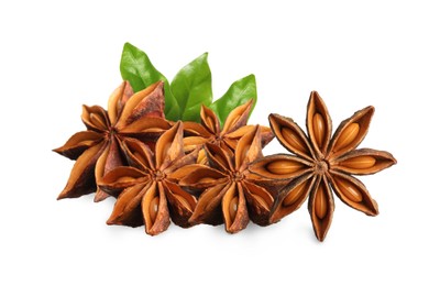 Aromatic dry anise stars and green leaves on white background