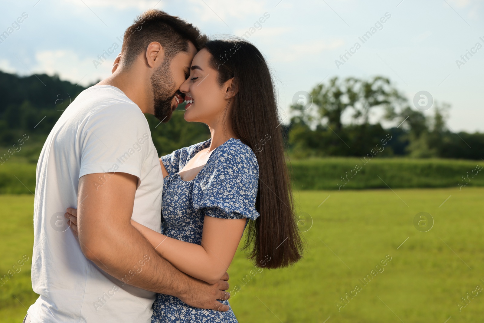 Photo of Romantic date. Beautiful couple spending time together outdoors, space for text